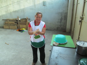Olga in front of her tortilla grill from her old business.  Preparing to cook the first tortilla for her new business.